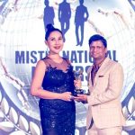 Sandeep Kumar receiving the Best Pageant Director award from the owner of Mister National Universe pageant, Tanya V in Thailand.